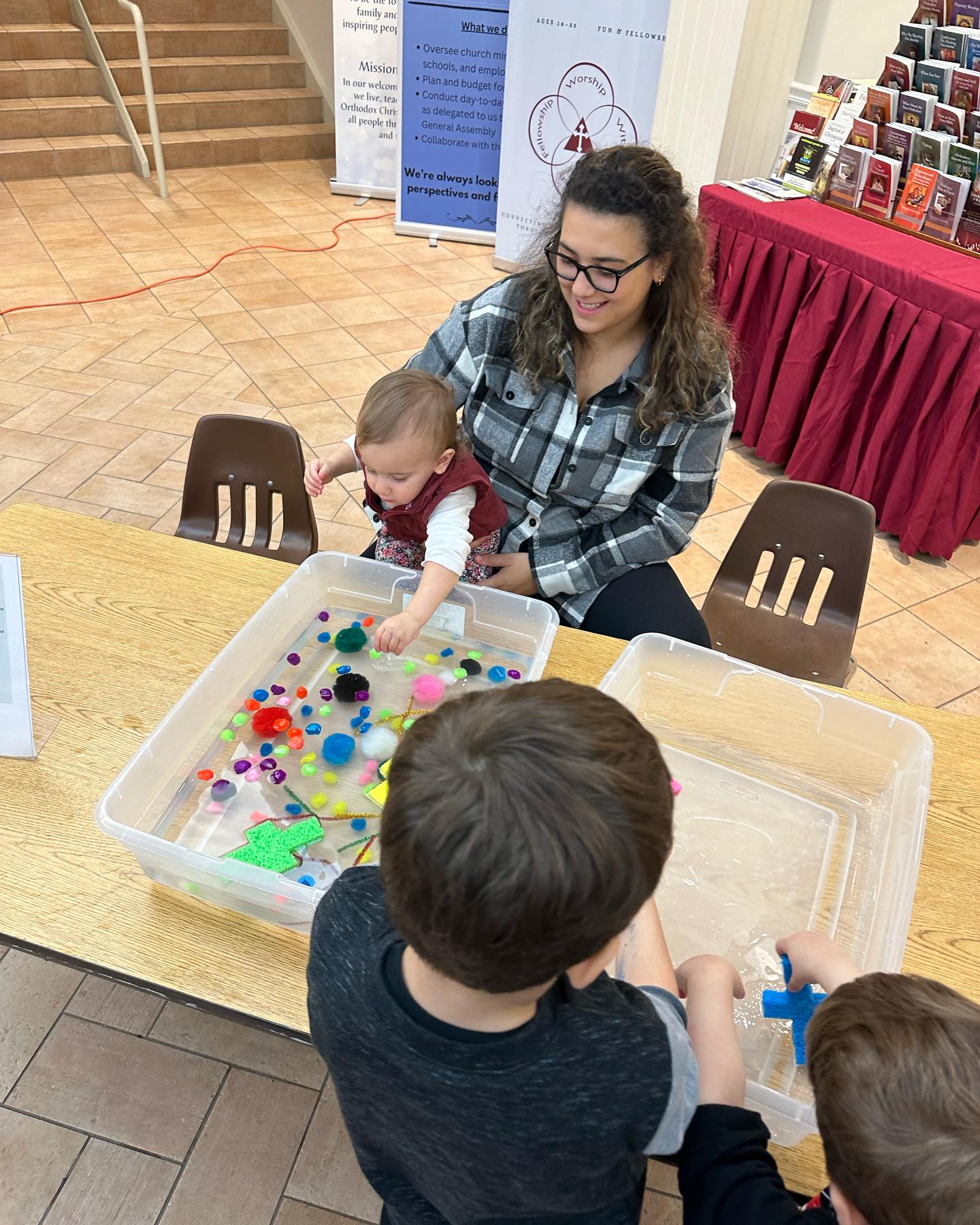 St-Nec-Web-Day-School-Image2-A Children exploring a sensory table in the Day School classroom