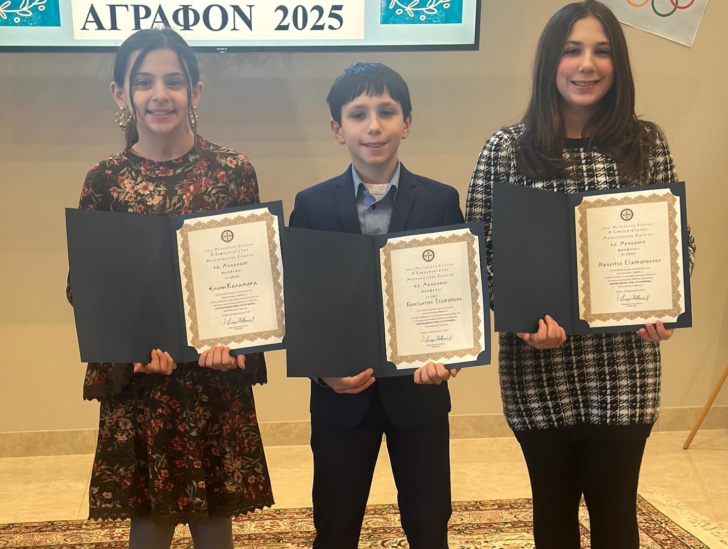 Greek School students holding their certificates