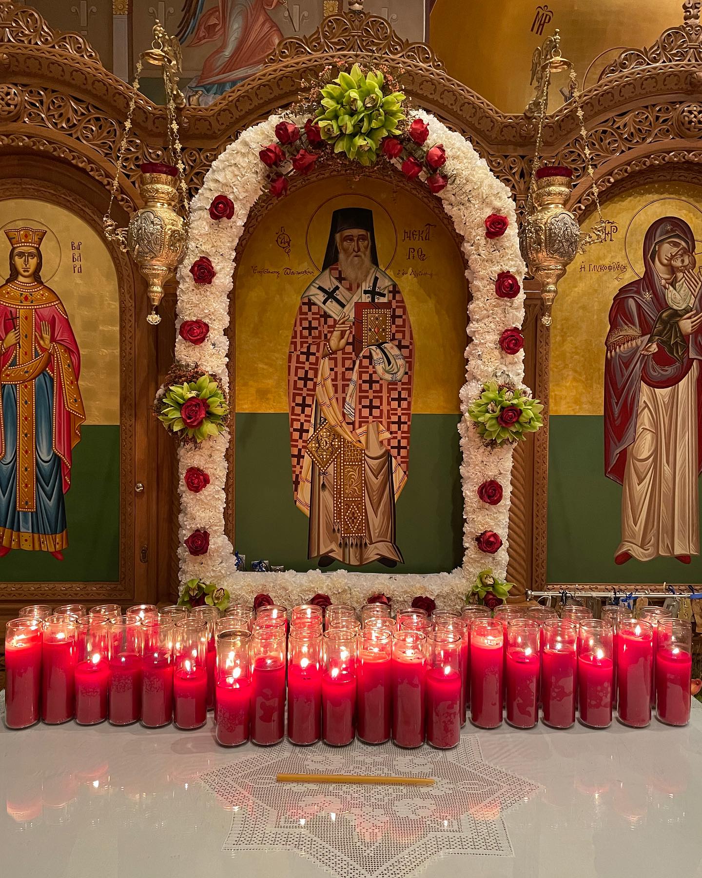 Icon of St. Nectarios on a shrine with candles for his feast day