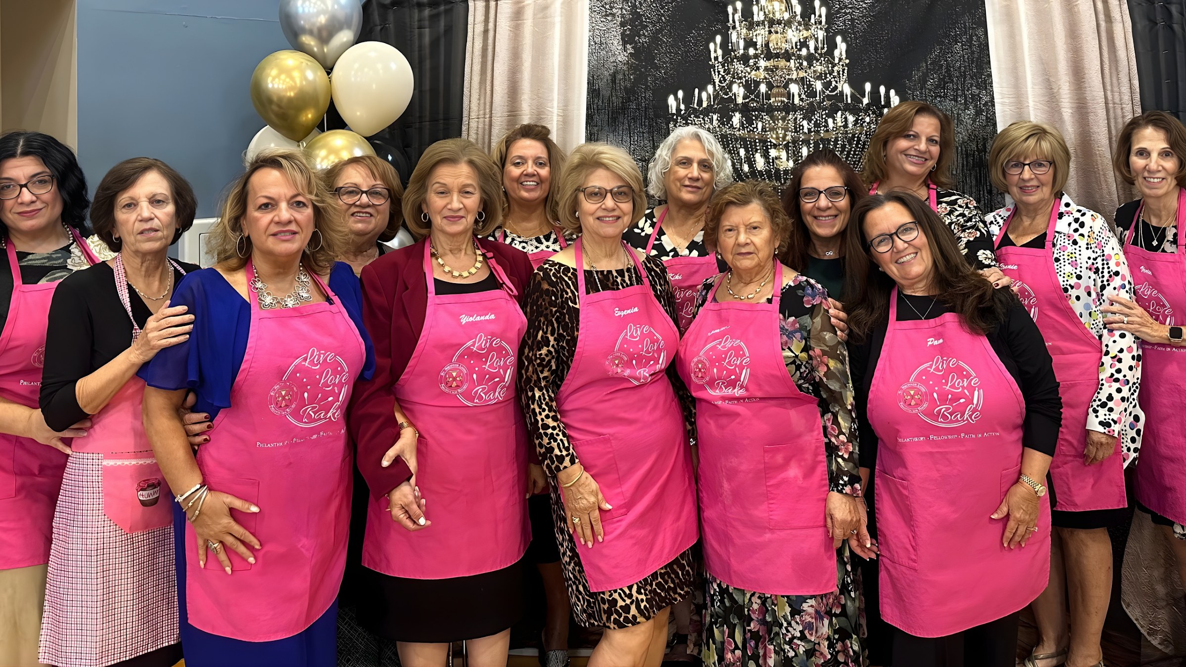 Parish volunteers in matching pink aprons gathered together