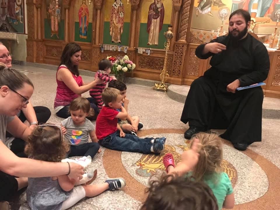 A priest teaching Sunday School children in the church