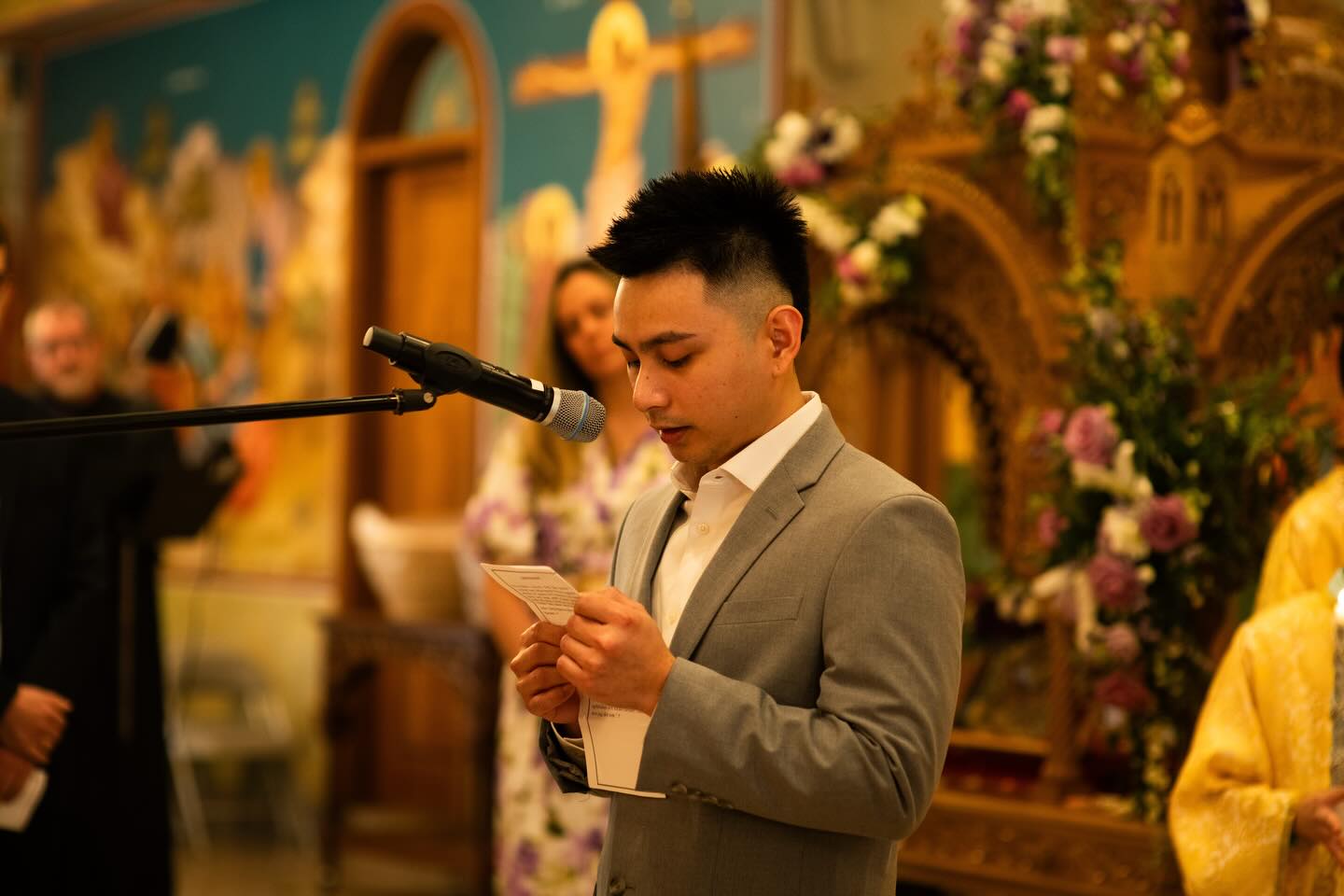 A Sunday School student reading at a podium in the church